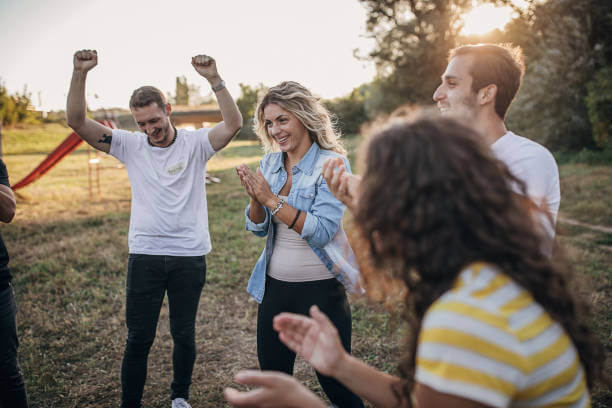 30 seconds 5 Group of creative young people standing in circle and clapping hands during team building seminar outdoors at public park